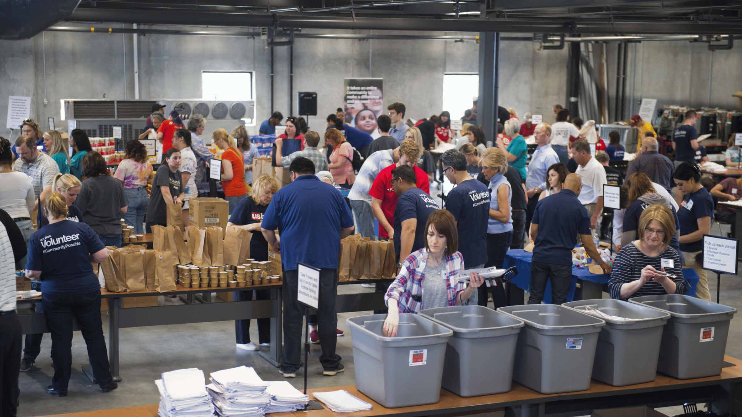 A group of volunteers together packing food