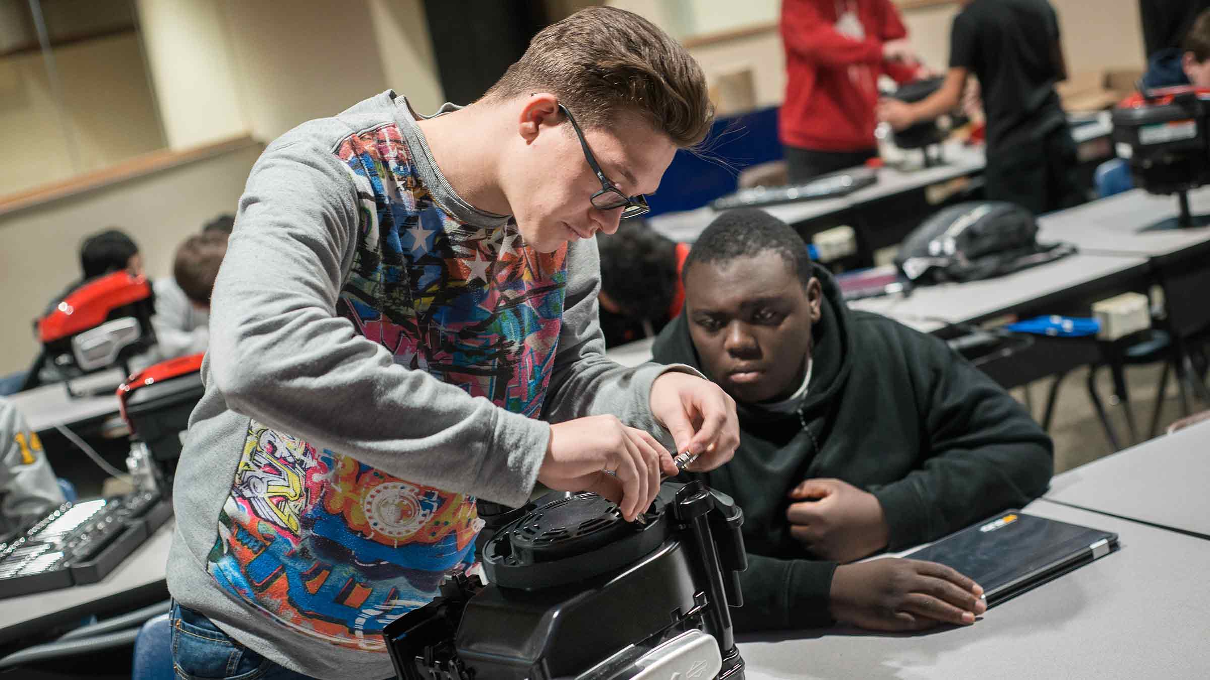 Two students are working together on a technical project