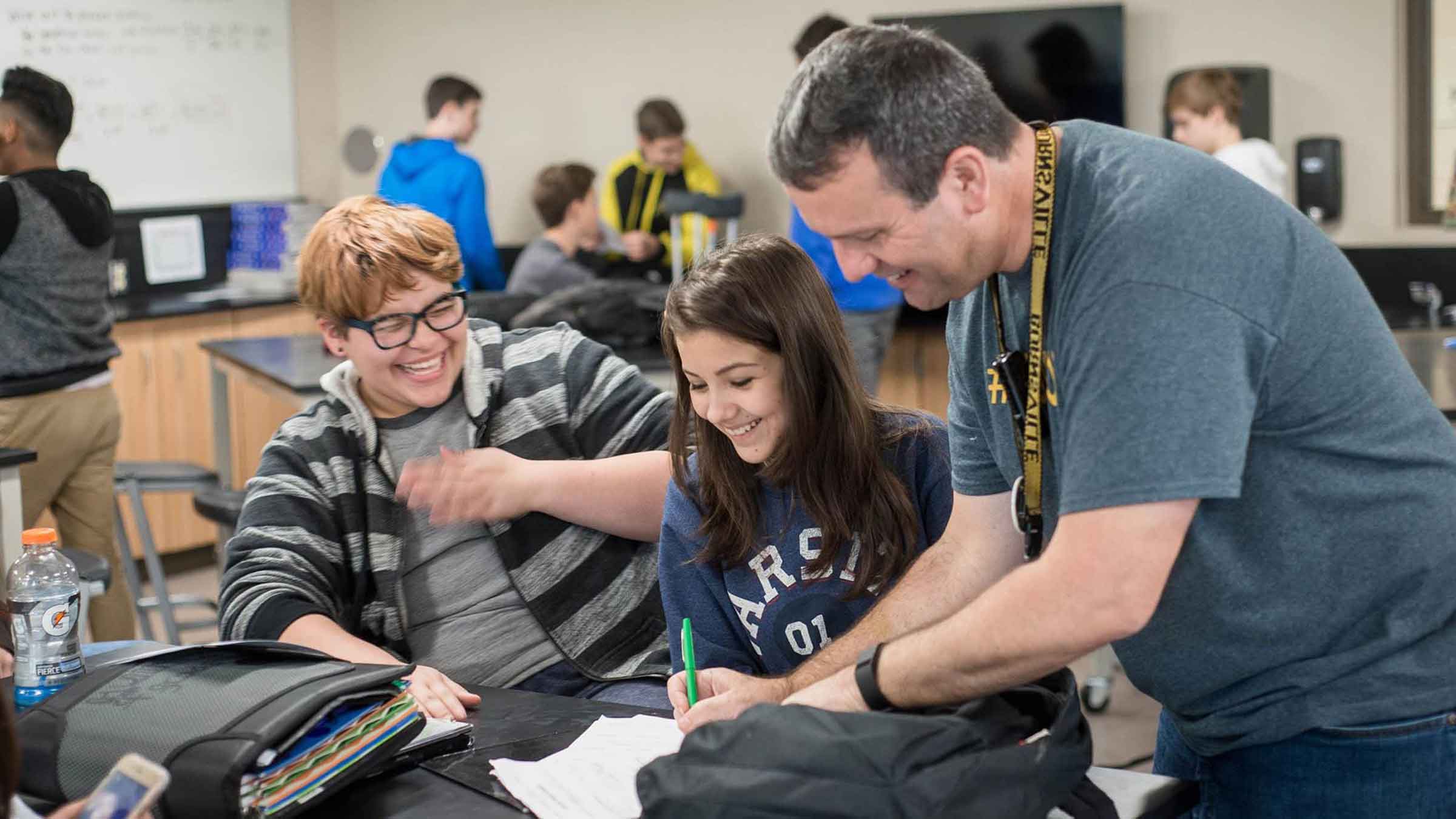 A teacher works with two students