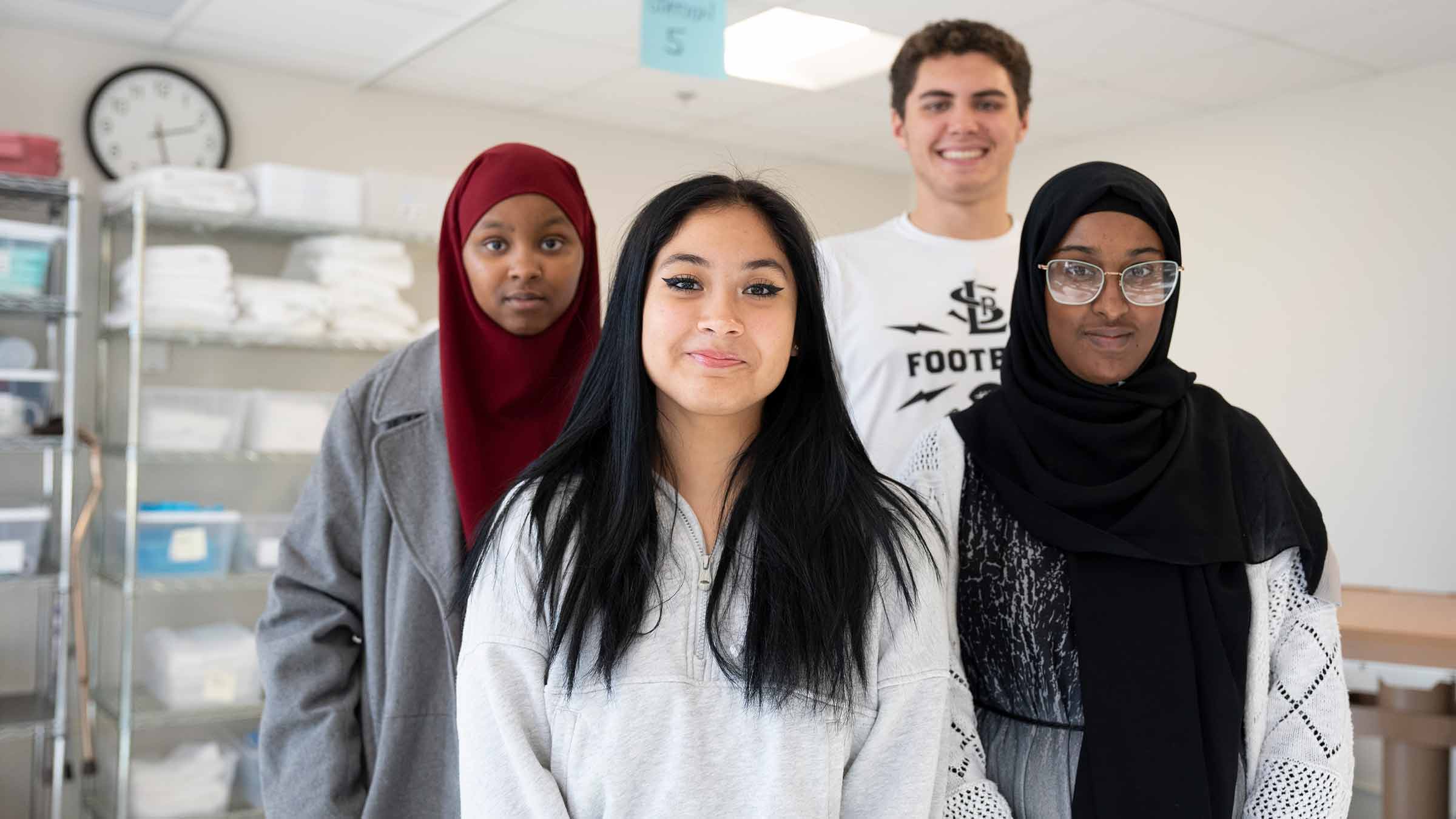 Career Academies students stand together as a part of a program that prepares them for work in healthcare