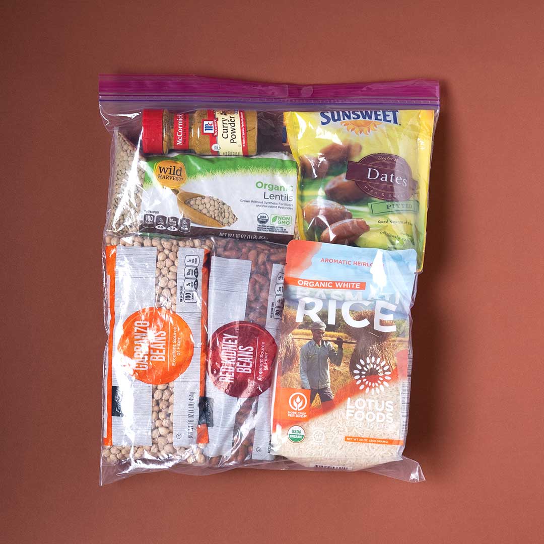 A Ziploc bag is filled with staple foods of the East African community including garbanzo beans, rice, and dates.