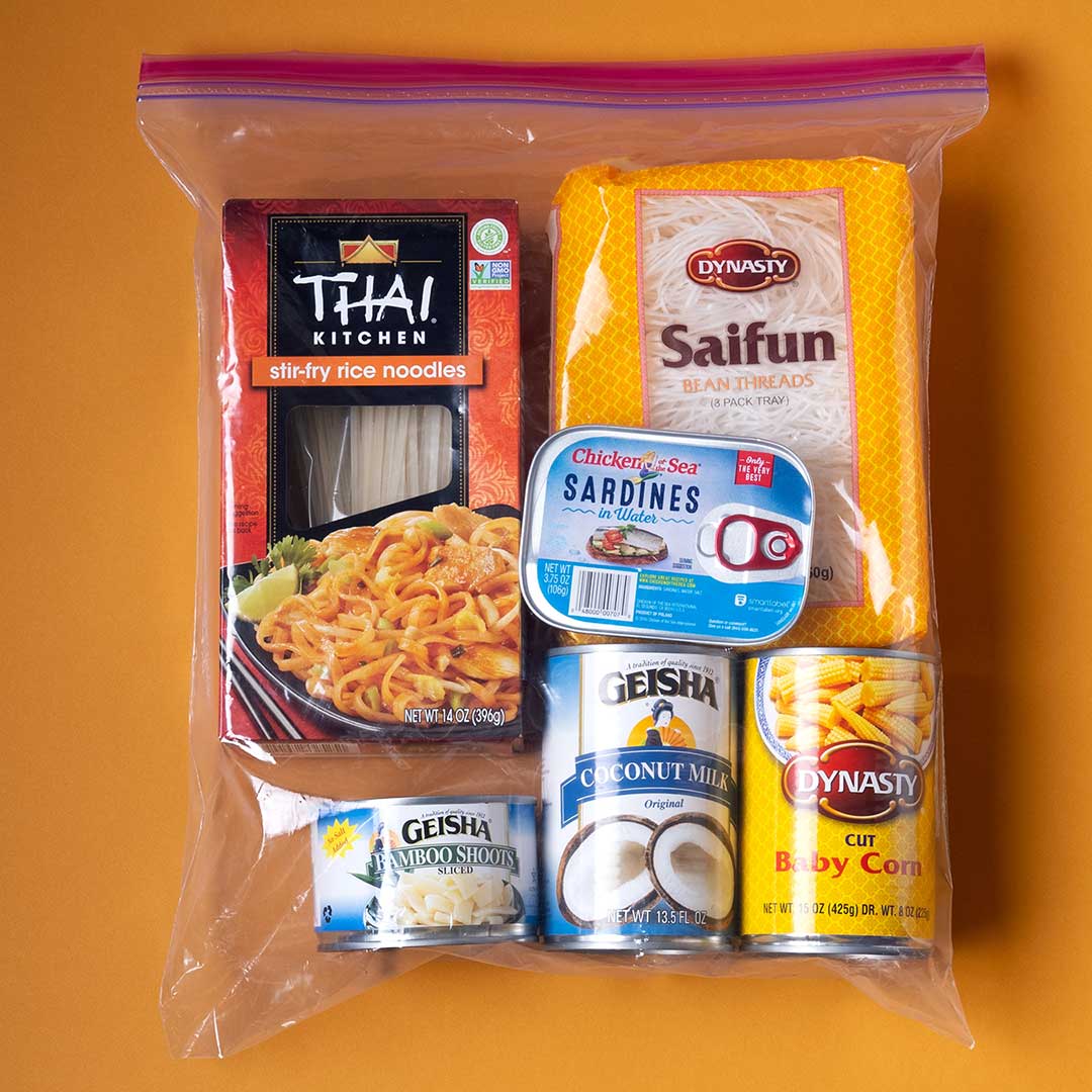 A Ziploc bag is filled with staple foods of the East Asian community including rice noodles, bean threads, and sardines
