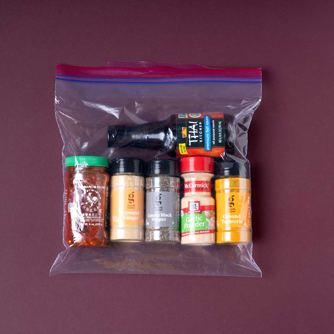 A Ziploc bag is filled with spices familiar to the Karen community including fish sauce, black pepper, and turmeric.