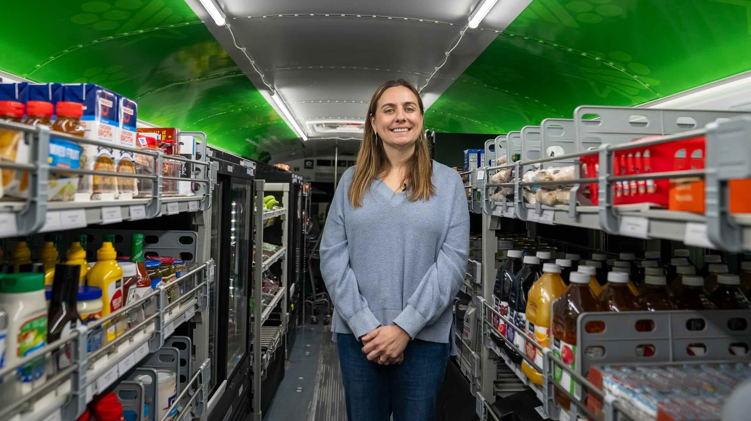Sophia Lenarz-Coy, executive director of The Food Group, standing in the Twin Cities Mobile Market Bus.